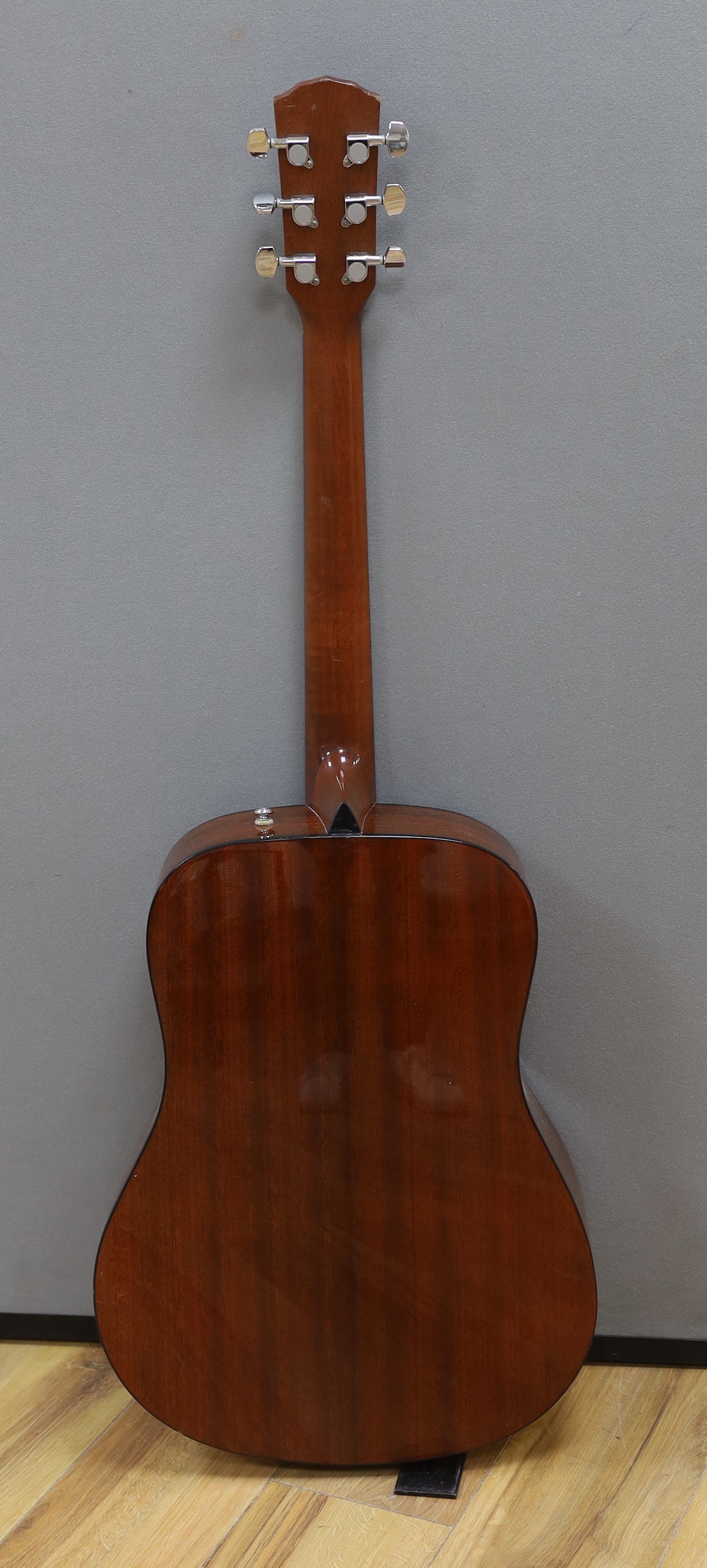 A Fender acoustic left handed guitar, in a hard case